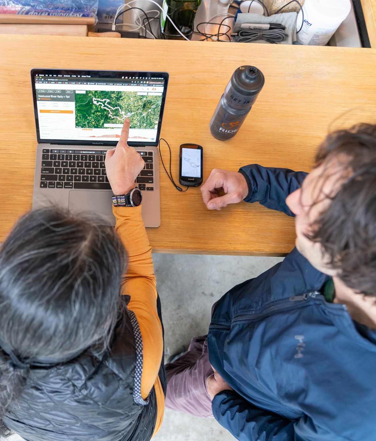 Two people looking at a laptop screen